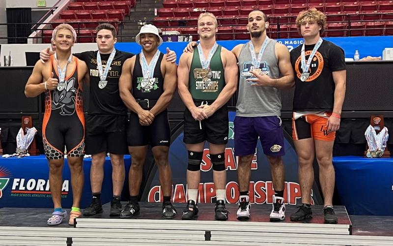 Columbia's Zaher Darwiche (second from right) placed third in the 199 class in Olympic at the Class 2A state meet on Saturday. (COURTESY)