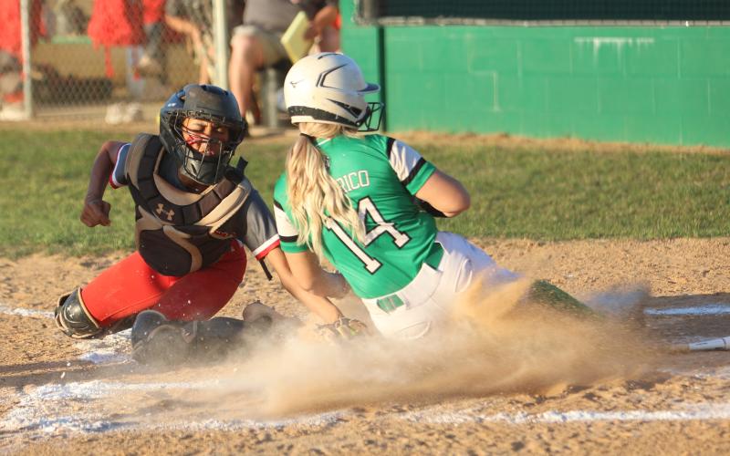 Suwannee’s Braylyn Federico is tagged out at home plate by Santa Fe catcher Madie Crosby on Tuesday night. (PAUL BUCHANAN/Special to the Reporter)