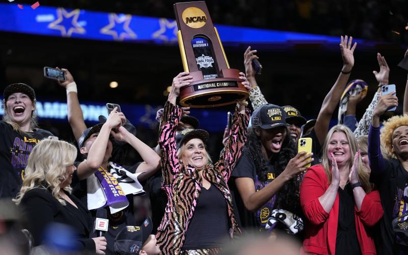 LSU head coach Kim Mulkey holds the winning trophy after the Tigers defeated Purdue in the national championship on Sunday in Dallas. (TONY GUTIERREZ/Associated Press)
