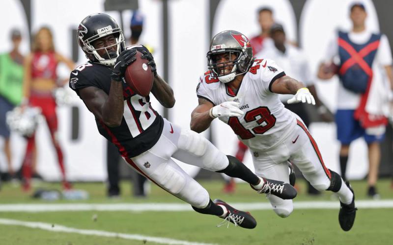 Former Atlanta Falcons wide receiver Calvin Ridley makes a diving touchdown reception in front of Tampa Bay Buccaneers defensive back Ross Cockrell on Sept. 19, 2021, in Tampa. (MARK LOMOGLIO/AP File)