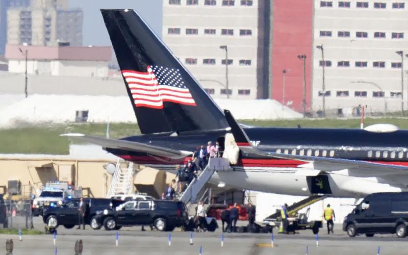 Former President Donald Trump’s aides and legal team exit his plane Monday in New York. Trump arrived for his expected booking and arraignment on charges arising from hush money payments during his 2016 campaign. (FRANK FRANKLIN II/Associated Press)