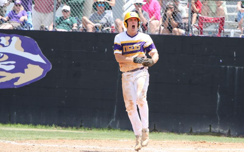 Columbia third baseman Ayden Phillips celebrates after drawing a bases-loaded walk against Lincoln, which tied the game 4-4 during Saturday's Region 1-5A semifinal. (BRENT KUYKENDALL/Lake City Reporter)