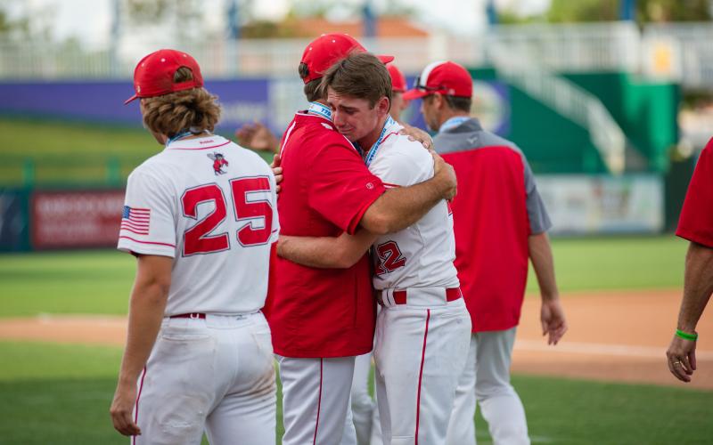 Lafayette's Landen Garrard is consoled following his team's loss to Chipley in the Class 1A state championship game on Thursday at Hammond Stadium in Fort Myers. (JESSICA PINALD/Special to the Reporter)
