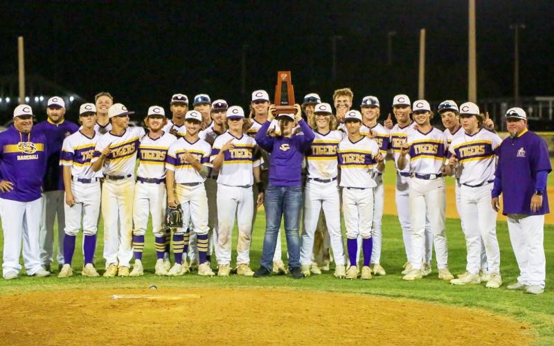 Columbia celebrates with the District 2-5A championship trophy after defeating Lincoln 9-0 on Wednesday night. (BRENT KUYKENDALL/Lake City Reporter)