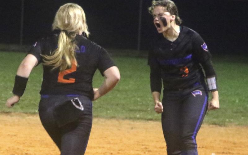 Branford pitcher Laila Arnold (left) races toward shortstop Cloey Criggall to celebrate their Region 3-1A semifinal win over Fort White on Thursday night. (MORGAN MCMULLEN/Lake City Reporter)