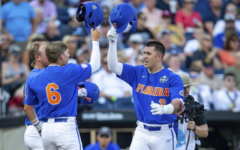 Florida outfielder Ty Evans (2) celebrates after his home run with Tyler Shelnut (6) in the second inning against Oral Roberts in their College World Series contest Sunday in Omaha, Neb. (JOHN PETERSON/Associated Press)