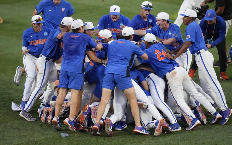 JOHN RAOUX/Associated Press Florida players and coaches celebrate on the field after defeating South Carolina in the Gainesville Super Regional game on Saturday.