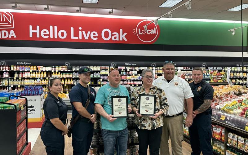 Ana Gienger and Stephan Little were issued life-saving awards from Suwannee County Fire Chief Eddie Hand and paramedics after performing CPR on a man suffering cardiac arrest at Winn-Dixie on June 14. (COURTESY SUWANNEE COUNTY FIRE RESCUE)