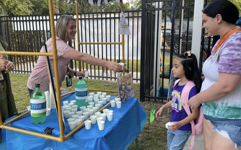 An Eastside Elementary School student is offered a cup of ‘jitter juice’ on Thursday, the first day of school. ‘Jitter juice’ makes the butterflies leave. (COURTESY)