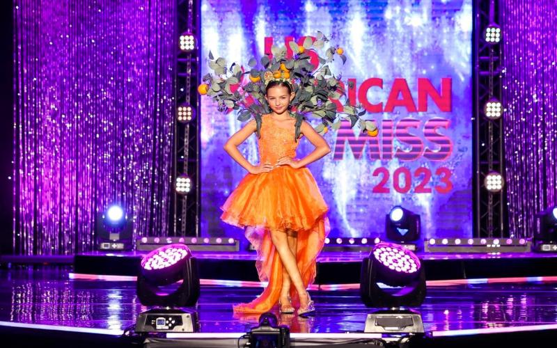 Lake City’s Molly Sue Wells poses on stage at the U.S. American Miss National Princess Pageant in Ponte Vedra Beach in her state wear costume. Wells eventually won the pageant, earning her the title of U.S. American Miss National Princess. (COURTESY)
