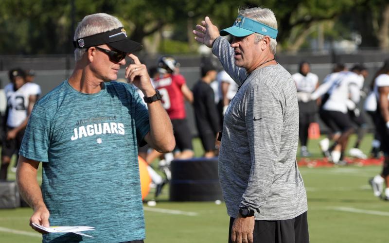 Jacksonville Jaguars head coach Doug Pederson (right) talks with quarterbacks coach Mike McCoy (left) during a practice on Aug. 1 in Jacksonville. (JOHN RAOUX/Associated Press)