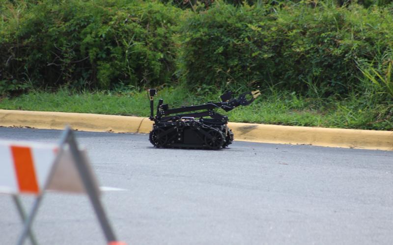 A robot drives down the driveway to the Quality Inn after entering to view the suspicious device left in a room at the hotel. (JAMIE WACHTER/Lake City Reporter)