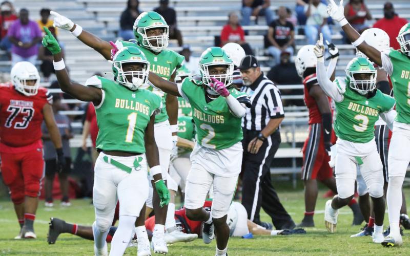 Suwannee defensive back PJ Davis (1), Amarion Rojas (2) and defensive end Ja’Darius Cherry (back) celebrate after their team’s fumble recovery against Munroe last Friday. (JAMIE WACHTER/Lake City Reporter)