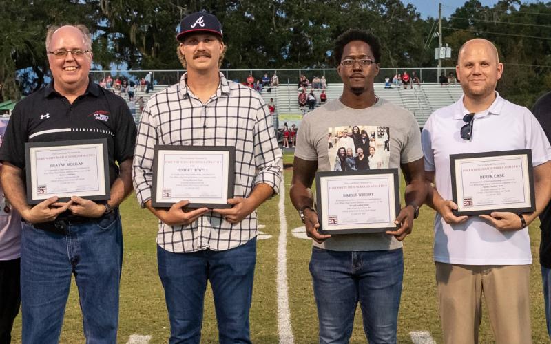 Shayne Morgan (from left), Robby Howell, Darius Wright and Derek Case were inducted into the Fort White High Athletics Hall of Fame on Friday night. Sitia Martinez, who was not in attendance, was also inducted. (JACK HOWDESHELL/Special to the Reporter)