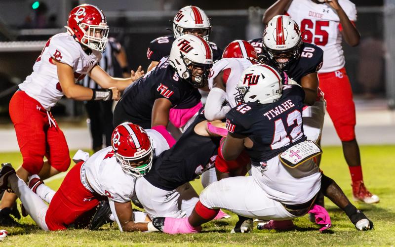 Fort White defenders converge for a tackle against Dixie County on Oct. 13. (JACK HOWDESHELL/Special to the Reporter)