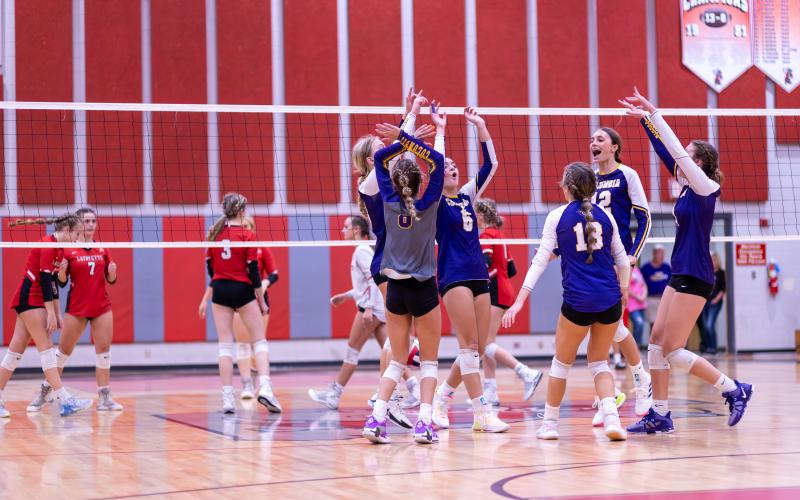 Columbia celebrates a point against Lafayette on Tuesday night. (JACK HOWDESHELL/Special to the Reporter)