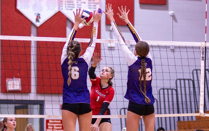 Lafayette hitter Brooke Lamb returns a shot as Columbia hitters Sinei Wood (6) and Kayla Goodloe (12) defend on Oct. 3. (JACK HOWDESHELL/Special to the Reporter)