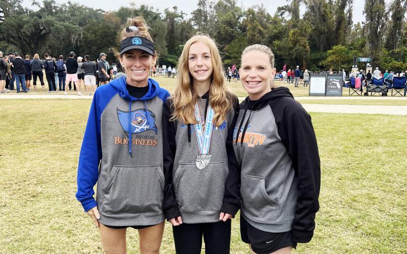Branford runner Anna Moore (middle) placed 12th at the Class 1A state meet on Friday. Moore is pictured with boys head coach Michelle Richards (left) and girls coach Stefani Santos (right). (COURTESY)