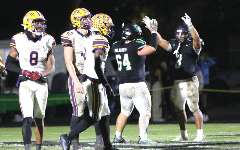Choctawhatchee running back Cole Tabb (3) celebrates after scoring a touchdown as defensive back Markeyon Moore (8), defensive end Ayden Phillips (40) and defensive back Lequawn Johnson (2) look on during Friday's Region 1-3S quarterfinal. (JORDAN KROEGER/Lake City Reporter)