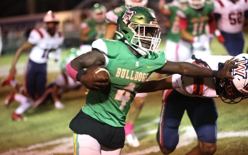 Suwannee running back Marquavious Owens stiff arms a Wakulla defender last Friday. (PAUL BUCHANAN/Special to the Reporter)