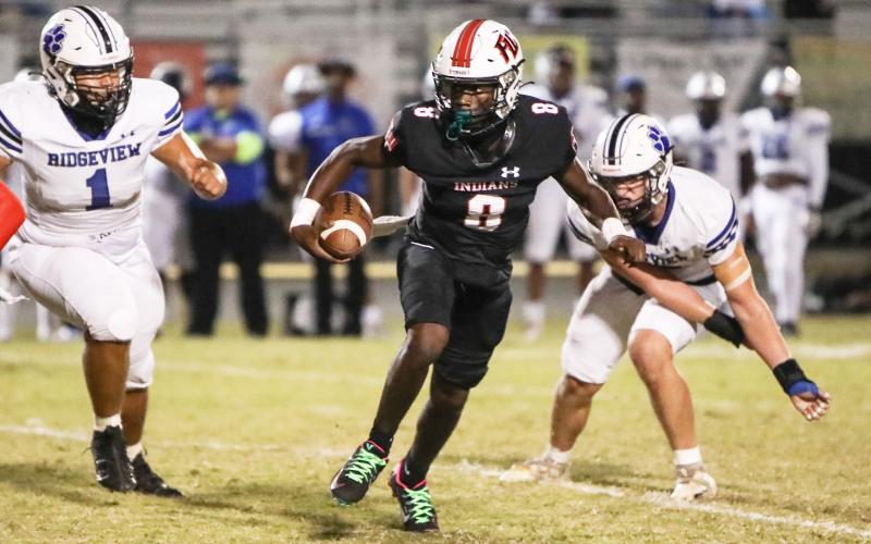Fort White quarterback Jayden Jackson scrambles up the field against Ridgeview on Oct. 20. (BRENT KUYKENDALL/Lake City Reporter)