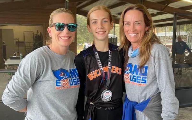 Branford’s Anna Moore (middle) placed sixth at the Region 2-1A meet on Thursday to qualify for state. Moore is pictured with girls head coach Stefani Santos (left) and boys head coach Michelle Richards (right). (COURTESY)