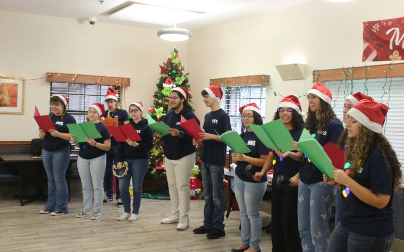 Fort White High School National Honor Society members sing Christmas carols while visiting the Robert H. Jenkins Veterans Domiciliary on Sunday afternoon. (TONY BRITT/Lake City Reporter)