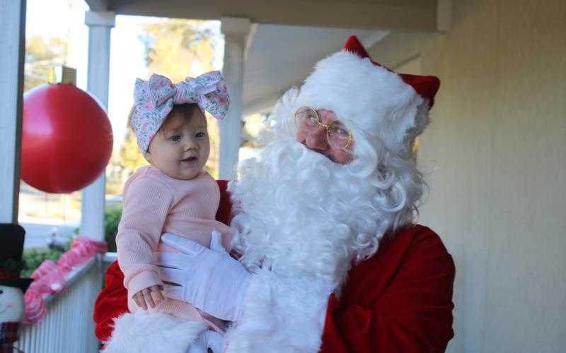 Santa Claus visits with Adeline Sage, six months old, on Tuesday afternoon at the Pregnancy Care Center. (TONY BRITT/Lake City Reporter)