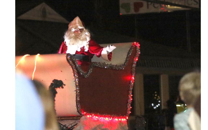 Santa Claus rides in the Live Oak Christmas parade last year. This year's parade, which was originally scheduled for Dec. 2, has been moved again to Friday due to inclement weather forecast Saturday. (FILE)