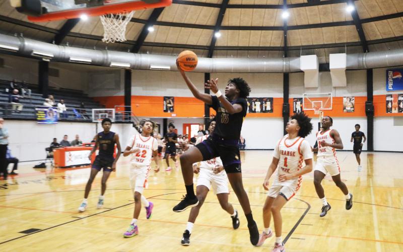 Columbia forward Zavian Douglas goes up for a shot against Orange Park on Friday night. (MORGAN MCMULLEN/Lake City Reporter)