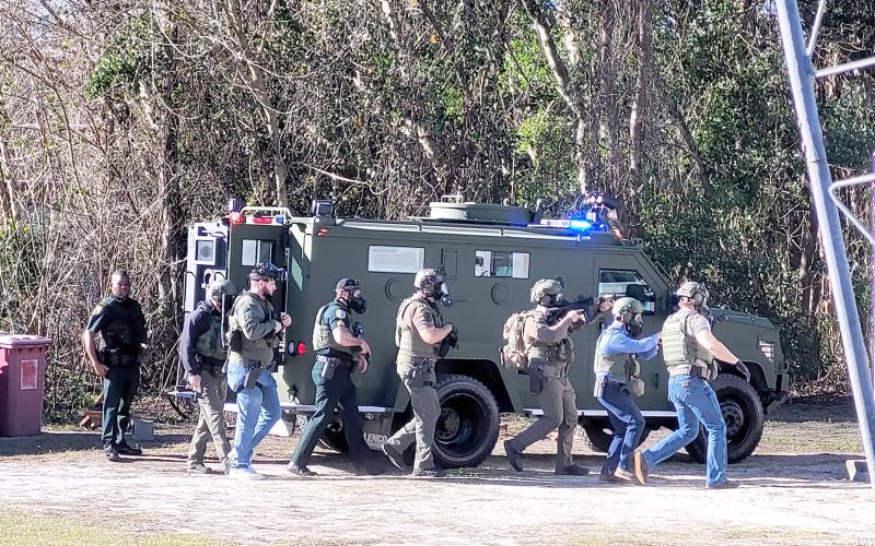Members of the Columbia County Sheriff’s Office SWAT team gather near the camper Wednesday morning. (COURTESY COLUMBIA COUNTY SHERIFF’S OFFICE)