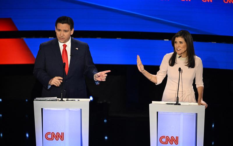 Florida Gov. Ron DeSantis (left) and former U.S. Ambassador to the UN Nikki Haley speak during the fifth Republican presidential primary debate, at Drake University on Wednesday in Des Moines, Iowa. (JIM WATSON/AFP/Getty Images/TNS)