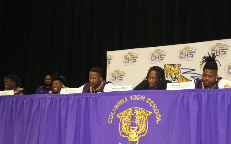 Columbia football players D'Mari Bruce (from left), Jalin Carter, Kani Fulton, Markeyon Moore and Wilson Philemon signed their letters of intent to play college football on Wednesday. (JAMIE WACHTER/Lake City Reporter)