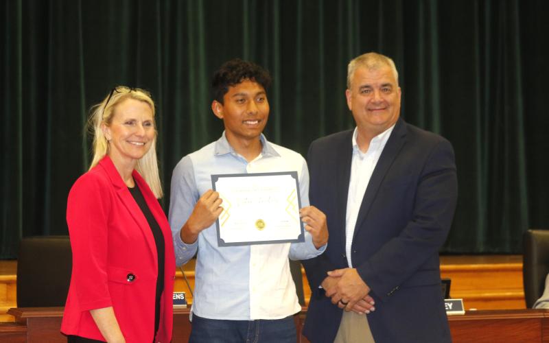 Columbia High junior Nathan Chowdhury was recognized by School Board Chair Dana Brady-Giddens (left) and Superintendent Lex Carswell (right) as the district’s Sunshine State Scholar at Tuesday’s board meeting. (JAMIE WACHTER/Lake City Reporter)