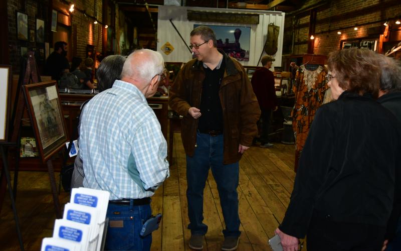 Suwannee County Historian Eric Musgrove (center) gives a tour of the Suwannee County Historical Museum during the All Aboard Festival in Heritage Square on Saturday. (ROB WOLFE/Special to the Reporter)