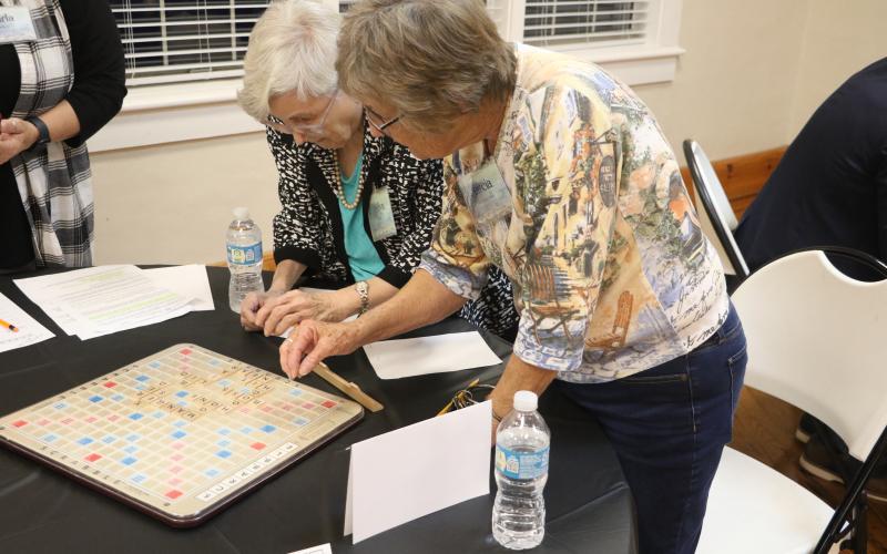 Marilyn Hamm (left) and Marcia Kazmierski look over their board in last year’s Lake City Garden Club Scrabble Tournament. (FILE)