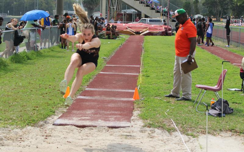 Columbia's Alli Jenkins leaps during the triple jump at the Raider Invitational on Saturday. (COURTESY)