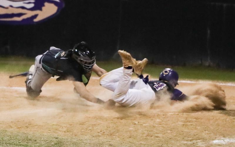 Suwannee catcher Jace Moran tags out Columbia second baseman Trayce McKenzie at home plate on Thursday. (BRENT KUYKENDALL/Lake City Reporter)