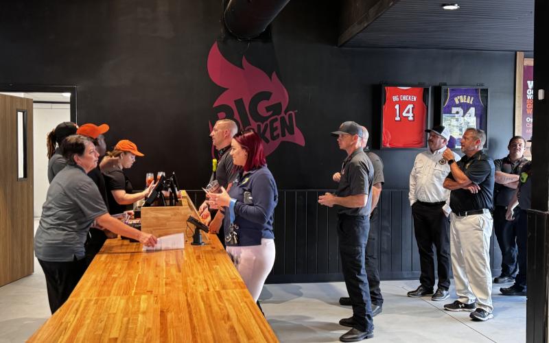 A line of first responders wait to order at Big Chicken during Tuesday’s sneak peek at the new Lake City restaurant. (JAMIE WACHTER/Lake City Reporter)