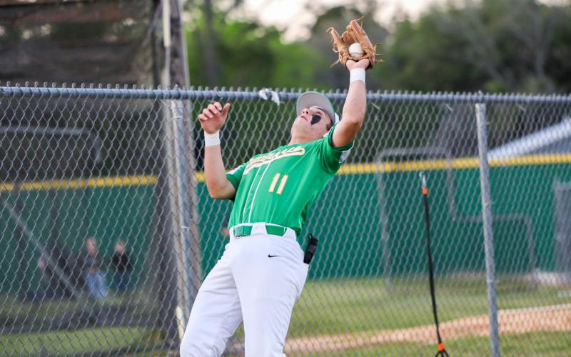 Suwannee third baseman Logan Brooks catches a pop up against Columbia on March 28. (BRENT KUYKENDALL/Lake City Reporter)