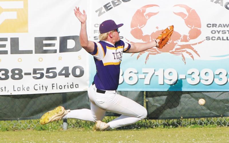 Columbia right fielder Max Schuler can’t catch up to a fly ball, which landed for a 2-RBI triple during an 11-0 loss to North Florida Christian on Tuesday. (JORDAN KROEGER/Lake City Reporter)