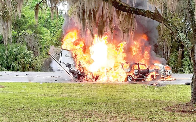 Two SUVs and a camper are engulfed in flames after a crash on State Road 136 near the State Farmer’s Market in White Springs on March 22. (COURTESY OF GLENN ALLEN)