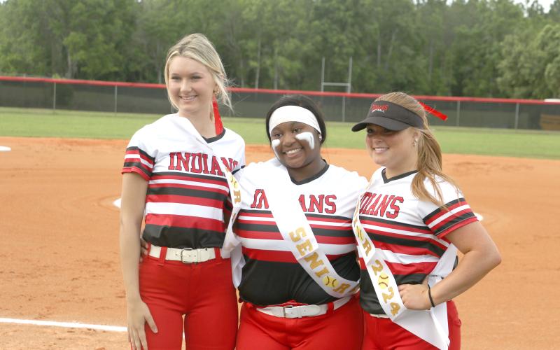 Fort White seniors Carly Caines (from left), N'Coreyia Atkins and Gracie Clemons pose ahead of Thursday's game against Dixie County. (MORGAN MCMULLEN/Lake City Reporter)