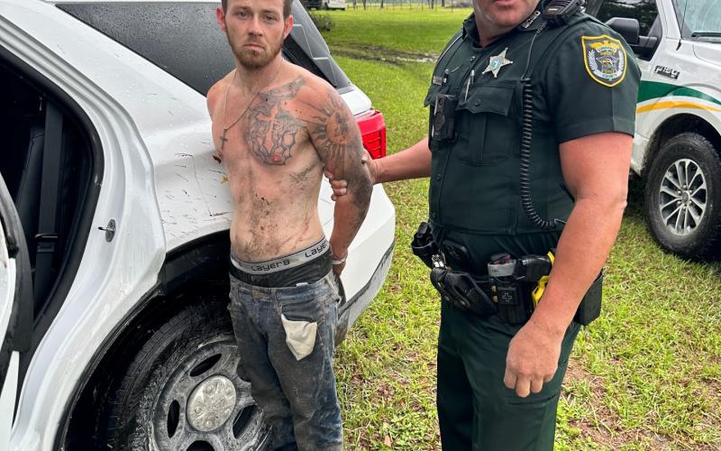 Samuel Sanders is handcuffed by Suwannee County Deputy Derek Slaughter after fleeing from an attempted stop and crashing in a stolen vehicle Wednesday. (COURTESY SCSO)