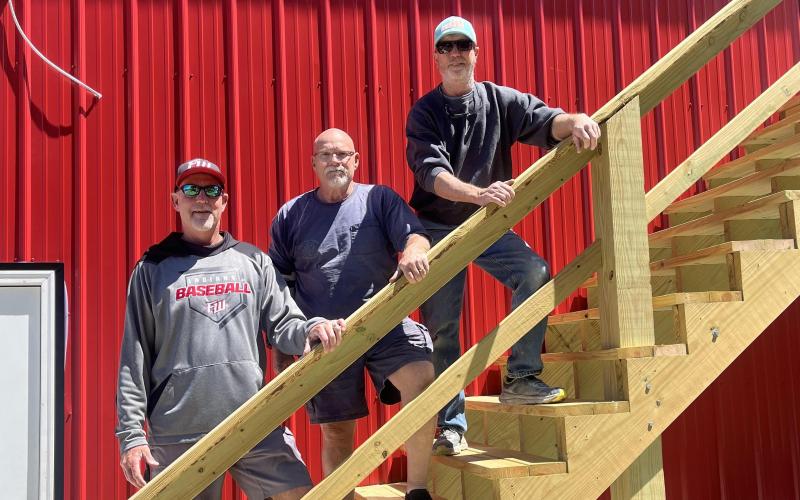 Fort White head coach Rick Julius (from left), Vernon Masters, and Sean Boyle stand at the new press box/concession stand at the Josh Barton Field. (WENDY FRAZIER/Special to the Reporter)