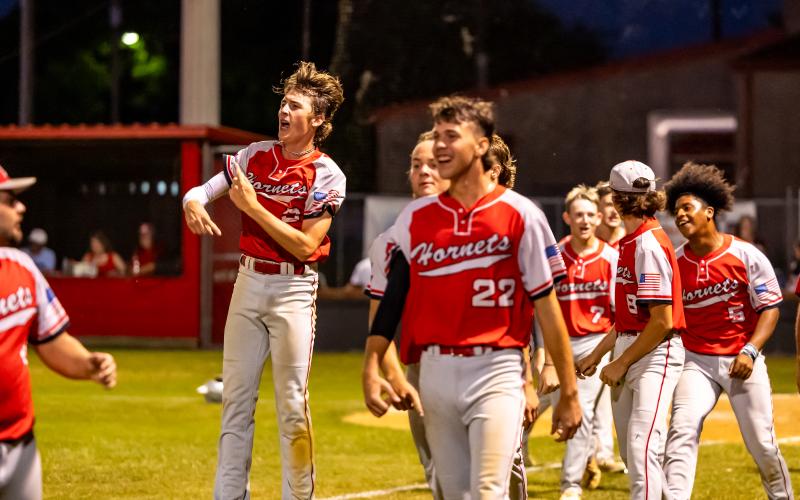 Lafayette's baseball team celebrates after defeating Madison County on a walk-off balk in Tuesday's Region 3-1A semifinal.