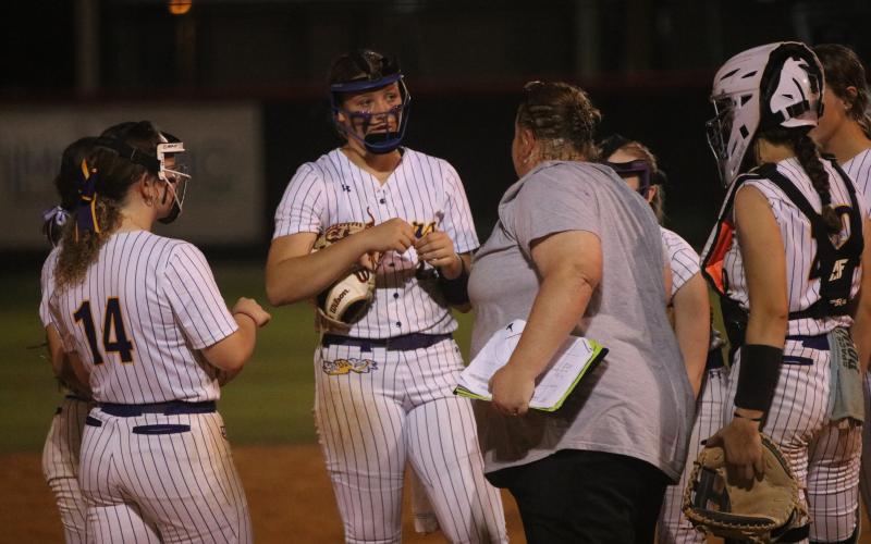 Columbia coach Cindy Dansby meets with pitcher Harleigh Price after Middleburg took a 2-1 lead in the sixth inning of Thursday's Region 1-5A quarterfinal. (JORDAN KROEGER/Lake City Reporter)
