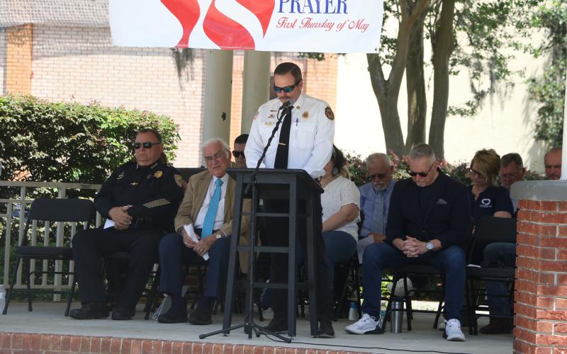 Lake City Fire Chief Josh Wehinger addresses the crowd as local and religious leaders listen during Thursday’s National Day of Prayer. (MORGAN MCMULLEN/Lake City Reporter)